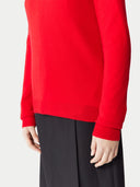 close up of a red sweater and black pants #color_hibiscus