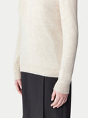 close up of a beige long sleeve sweater and a black skirt. #color_birch