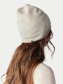 back view of a white beige beanie with a small tag label "GOBI" #color_birch