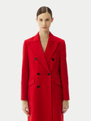A person wearing a red cashmere peak lapel long coat with double-breasted design and a V-neck collar.  #color_red