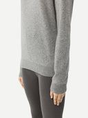 close up of a sray sweater worn by a person on a white background
#color_vapor-blue