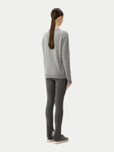 back view of a Person wearing a gray sweater and dark leggings on a white background 
#color_vapor-blue