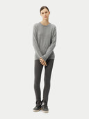Person wearing a gray sweater and dark gray leggings on a white background
#color_vapor-blue