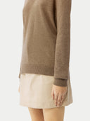 close up of a brown sweater and a white skirt #color_taupe