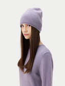 Person wearing a light purple beanie and sweater on a white background #color_purple-ash