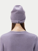 back view of a gray purple sweater and beanie with a small brand label #color_purple-ash