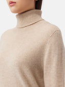 close up of a beige turtle neck sweater #color_warm-grey