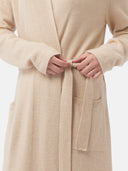 close up bottom side view of a beige bathrobe with belt and pockets #color_beige