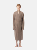 Person wearing a brown robe on a white background. #color_taupe