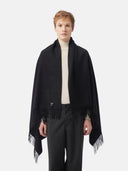 Man wearing a black blanket with fringes on a white background #color_black