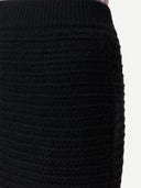 Close-up of a black knitted skirt on a white background #color_black