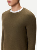 Brown crew-neck sweater worn by a person on a white background #color_cub