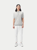 front view of a man wearing a gray polo shirt with white pants #color_vapor-blue