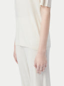 close up of a white top and pants #color_whisper-white