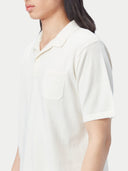 close up of a white polo shirt with pocket #color_whisper-white