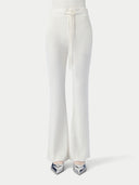 A pair of white drawstring ribbed cotton silk cashmere blend flares with a wide-leg cut, displayed on a model without showing the upper part of the body. #color_whisper-white