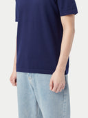 close up of a navy t shirt of bottom side and wearing a blue jeans #color_navy