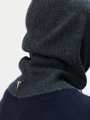 back view of a dark gray knit cowl worn by a person on a light gray background #color_charcoal