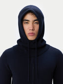 Person wearing a navy blue hoodie against a white background #color_navy-blazer
