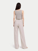 back view of a woman wearing a sleeveless top and wide-leg pants on a white background  #color_dawn-blue