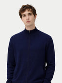 Man wearing a navy blue zip-up sweatshirt on a light gray background #color_navy