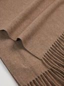 Close-up of a brown scarf with fringe details on a light gray background.