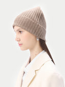 side view of a beige minimal rib knit beanie and white coat #color_taupe