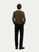 back view of a man wearing a green sweater and black pants on a white background #color_burnt-olive