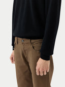 close up of a black cardigan, brown pants standing against a plain background. #color_black