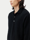 close up of a black polo long sleeve sweater on a gray background #color_black