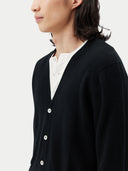 close up of a black v-neck cardigan over a white shirt  #color_black
