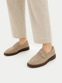 Beige loafers worn with beige pants on a white background #color_warm-grey
