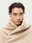 Man wearing a beige coat against a plain background #color_beige