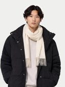 front view of a man wearing a black coat and white scarf against a white background #color_white