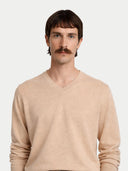 Man wearing a beige sweater against a white background #color_beige