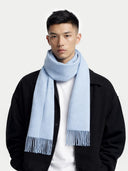 Man wearing a light blue scarf with a plain background #color_light-blue