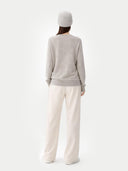 back view of a person wearing a gray sweater and white pants on a white background #color_dawn-blue