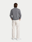 back view of a man wearing a gray sweater and white pants on a white background #color_dim-gray