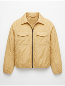 A light tan nylon utility jacket with a zippered front, collar, and two flap chest pockets, shown against a plain white background.