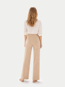 back view of a white blouse and beige pants on a white background #color_beige