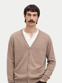 Man wearing a beige cardigan over a white shirt on a light gray background #color_taupe
