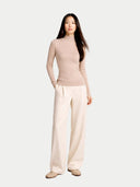 front view of a woman wearing a beige sweater and wide-leg pants on a white background #color_beige