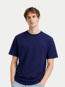 Man wearing a navy blue t-shirt against a light gray background #color_navy