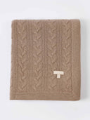 A beige cable knit cashmere blanket with a textured pattern displayed flat. #color_taupe