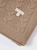 close up of a brown cable knit blanket with small label "GOBI ORGANIC" and "F" #color_taupe