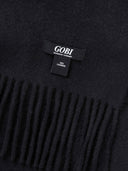 close up of a black blanket details with fringes, with brand tag "GOBI".