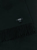 a zoomed-in shot of a black fringed cashmere blanket with a black brand label "GOBI" #color_black