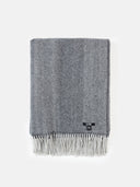 A gray and white super soft woven cashmere throw with fringes at the bottom. #color_charcoal