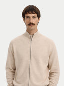 Man wearing a beige zip-up sweater against a white background #color_beige