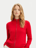 Woman wearing a red zip-up sweatshirt on a light gray background #color_racing-red